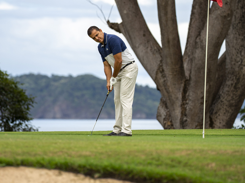 Golfer playing on an ocean-view golf course in Guanacaste